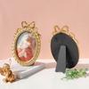 Handcrafted Antique Gold Carving Oval Bowknot Picture Frame With Hanging Hook And Stand For Wall Or Desktop Decoration