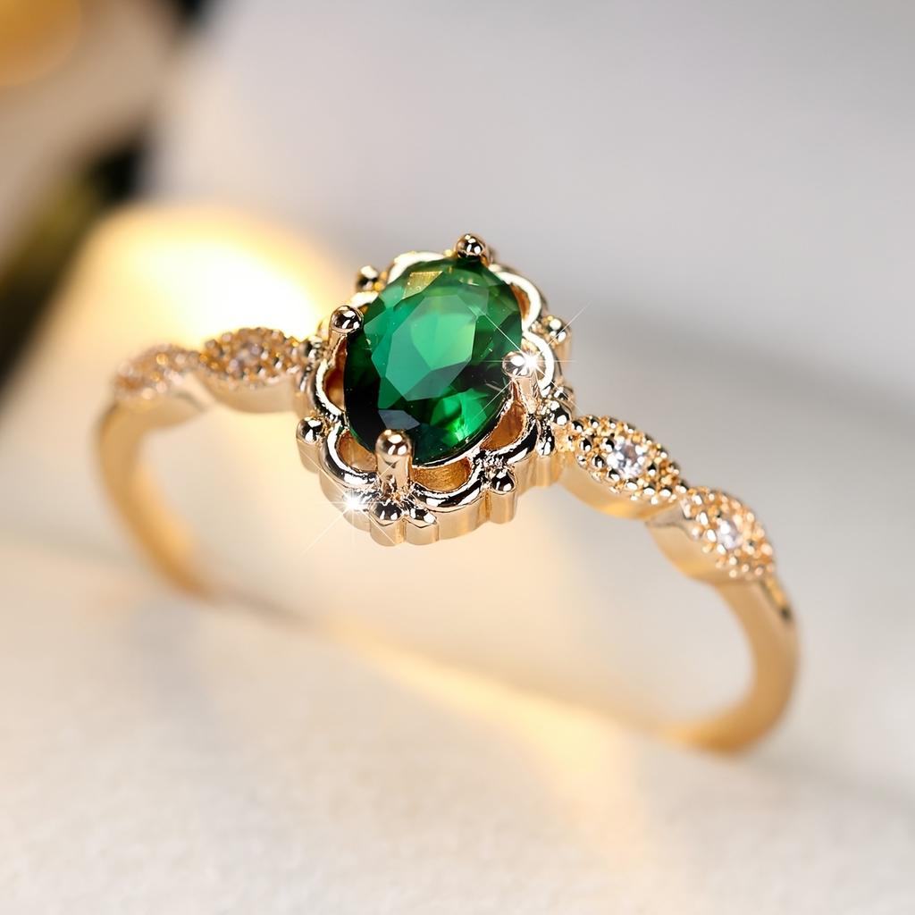 A ring inlaid with egg-shaped green synthetic zirconia, featuring a lace design, is elegant, simple, classic, exquisite, fashionable, luxurious, and