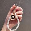 Mobile phone pearl lanyard, small fragrant style, short hand-held belt card, universal anti-loss, new lanyard, strong handmade string women