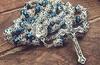 Catholic necklace with deep blue crystal crown beads, rosary, sacred earth medal and cross.