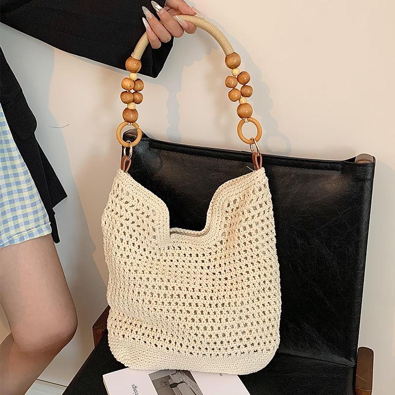 Lässige Baumwollfaden-Flechtbeutel mit großem Fassungsvermögen, neue hohle handgewebte Schultertasche, Urlaubs-Strandtasche, vielseitige Damentasche