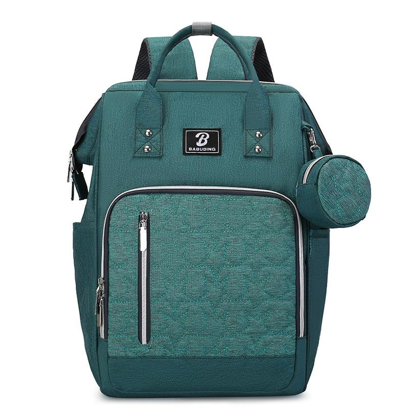 New style mommy bag with large capacity, featuring a patchwork design, contrasting colors, and a versatile, fashionable look. It’s a waterproof