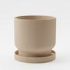 A Modern, Light Beige Flowerpot with a Drip Tray, Simple and Functional.