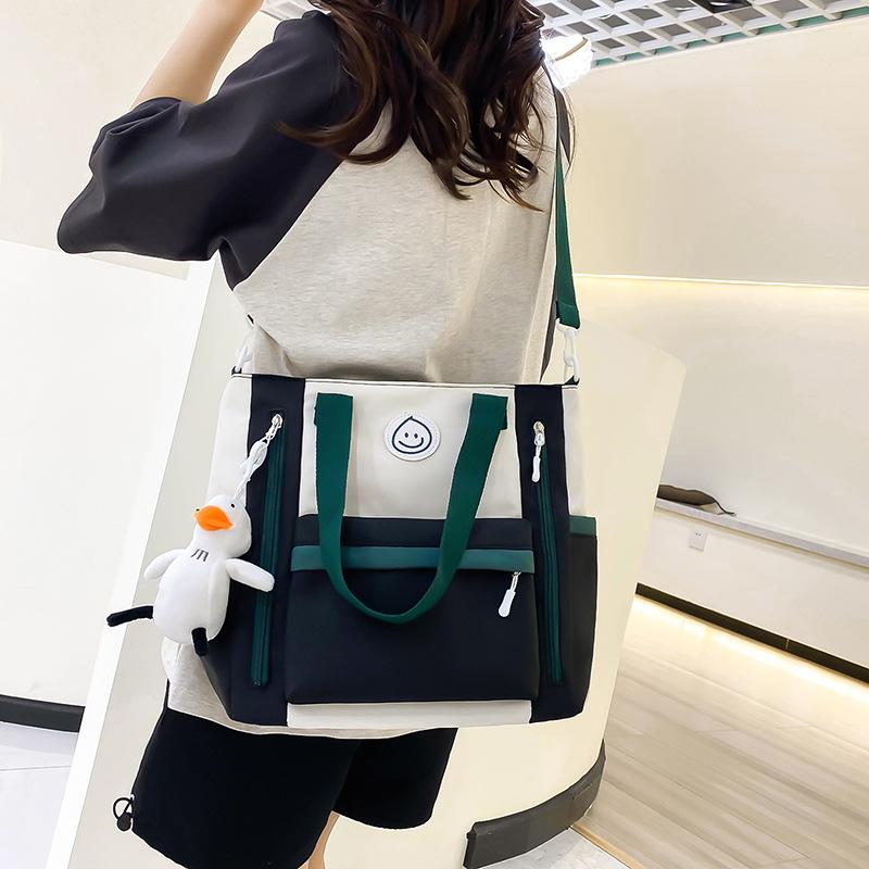 Contrasting color leisure large-capacity tutoring bag, junior and high school students book bag, hand bag in class, high-value messenger bag for women