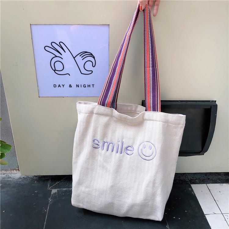 

Korean fabric embroidered smiley face large capacity student shoulder women s bag bag