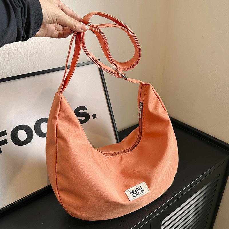 

Japanese solid color canvas bag women s new lightweight small messenger bag student sports and leisure waterproof dumpling bag помаранчевий