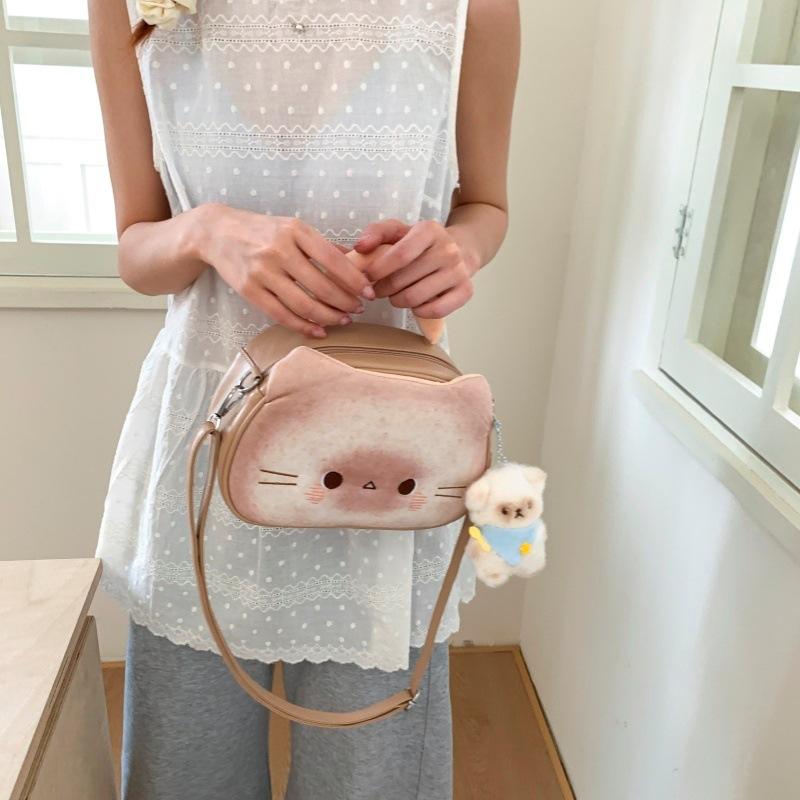 Internet celebrity cute biscuits kitten bag 2025 new Japanese cartoon girl foreign versatile messenger small round bag tide