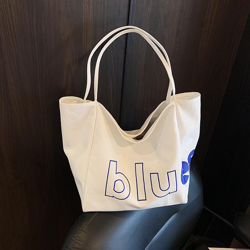 

Модный тренд 2025 года новая сумка в иностранном стиле большой вместимости летняя личность досуг простая женская наплечная сумка-тоут белый