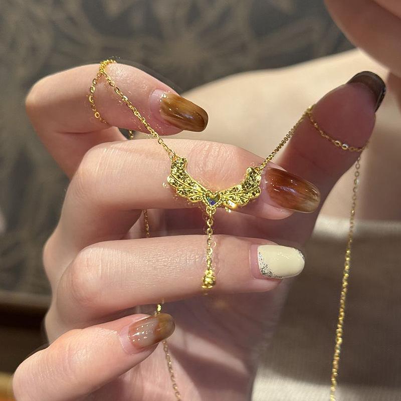 Inspiration design Glossy diamond studded crushed ice wings necklace heart-shaped tassel small golden ball collar chain