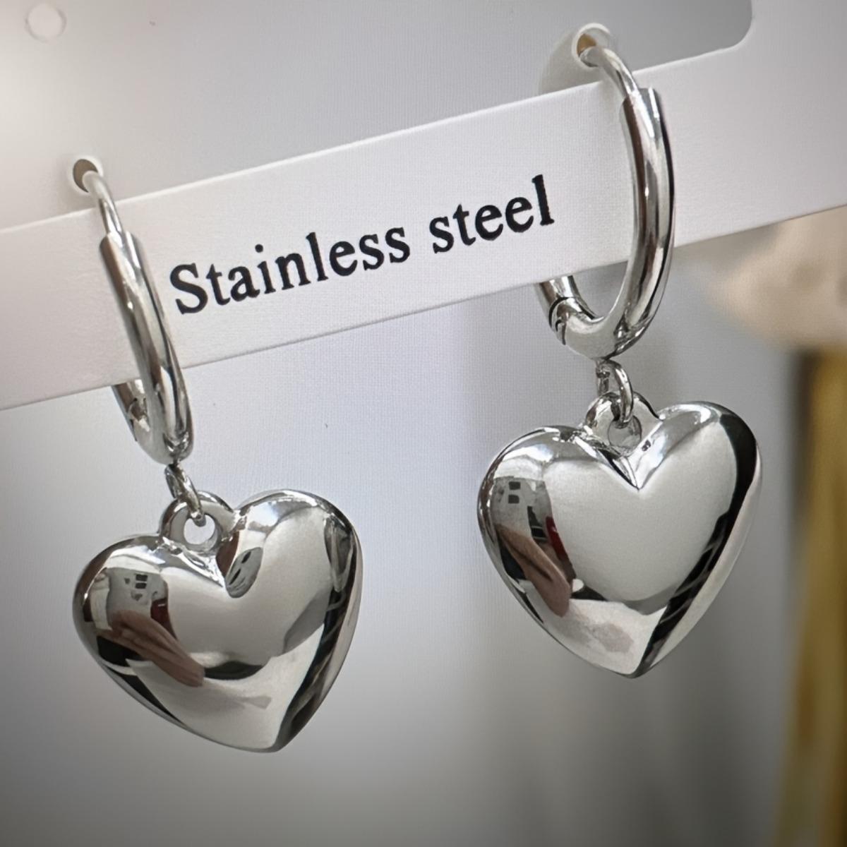 

A pair of heart-shaped earring pendants made of stainless steel; fade-resistant and perfect for everyday wear by women срібний