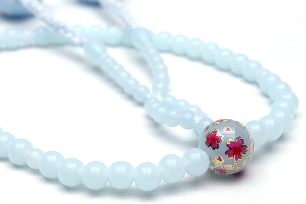 Japanese-made Soka Gakkai prayer beads set, perfect as a gift for new members. Includes a pink and cherry blossom design on the beads and a light blue