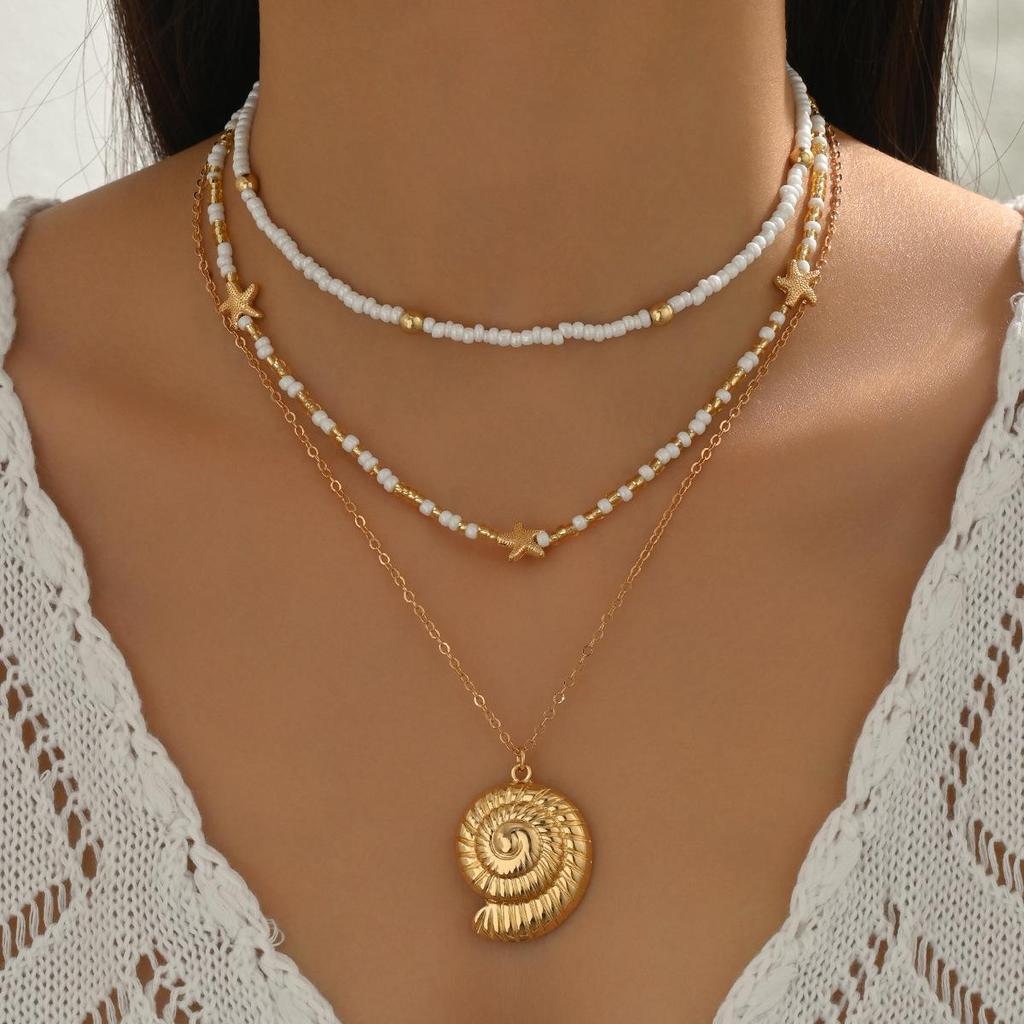 Starfish & Conch Pendant Necklace - Versatile Fashion Jewelry with Rice Bead Clavicle Chain for Women.