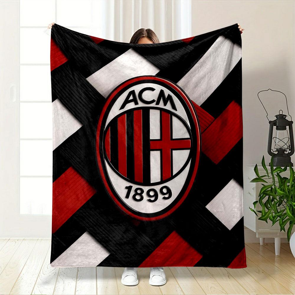 Interwoven red, black, and white strips with an oval emblem in the center. for all seasons blanket lunch break throw gift