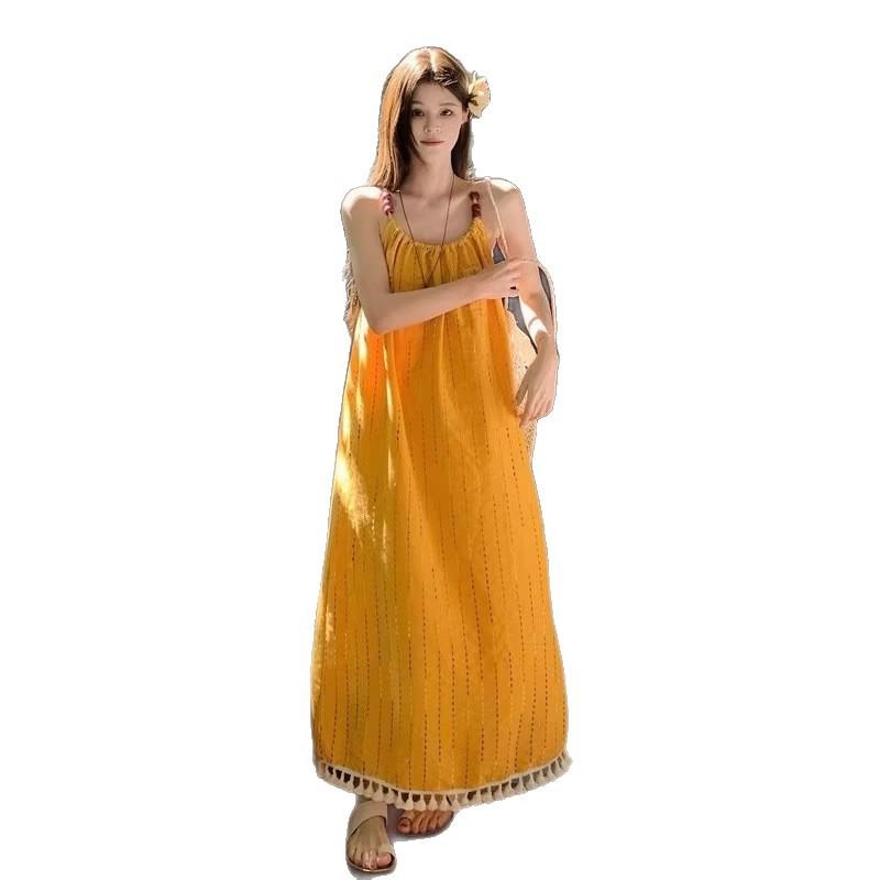 Beach vacation wind yellow fringed suspender dress women's summer 2026 new temperament loose A-shaped long skirt