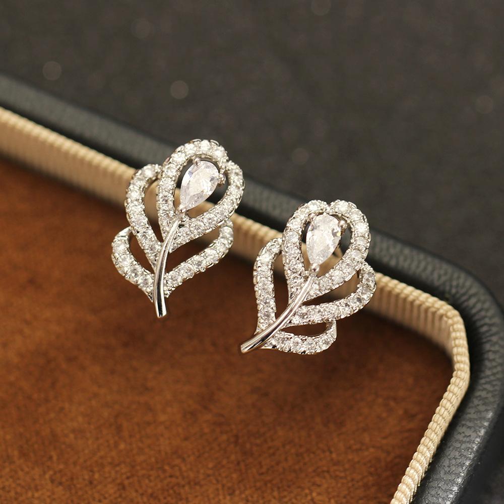 Simple temperament Korean version stone-inlaid purple white feather earrings gold-plated versatile women's stud earrings niche