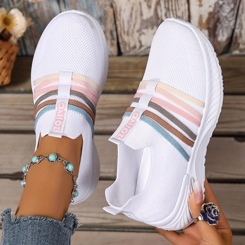 The Lady Wears Slip-On Casual Sports Shoes, Featuring a Breathable Mesh Design with Pastel Stripes, Suitable for Tennis And Comfortable
