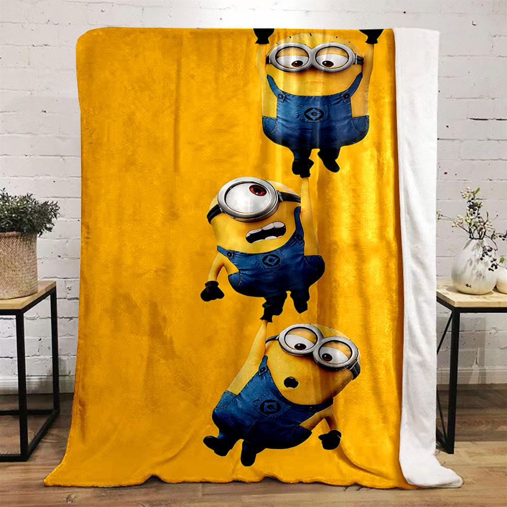 Three Minions in blue overalls hanging from each other on a yellow background. for all seasons blanket lunch break throw gift