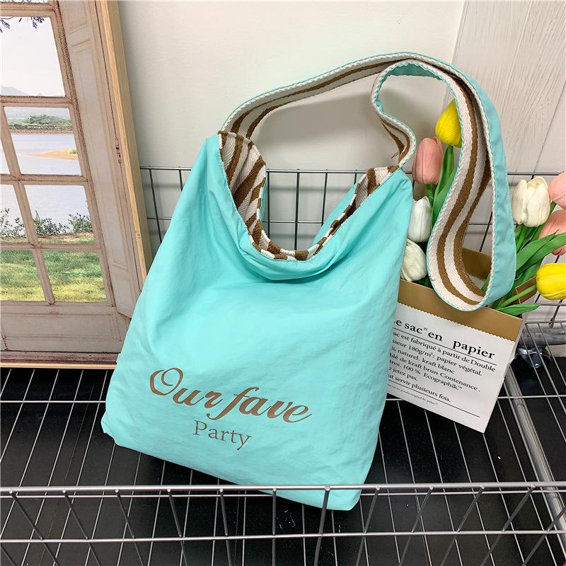 

Casual large-capacity striped canvas bag women s 2025 new commuter shoulder bag lightweight versatile tote bucket bag 27*12*33
