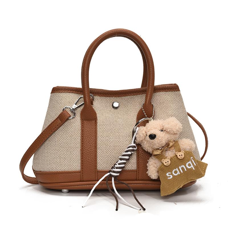 Korean version of casual niche contrasting color splicing portable bucket bag fashion versatile temperament casual commuter messenger bag woman