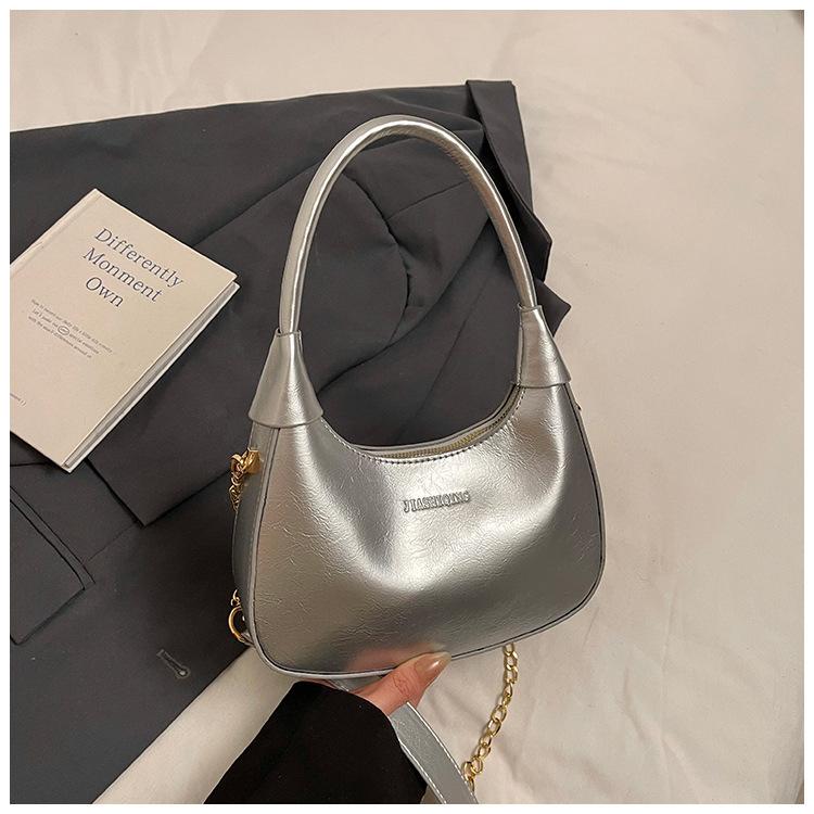 Fashion birth girl small bag 2025 new patent leather design sense portable crescent bag hand carry niche unique underarm bag