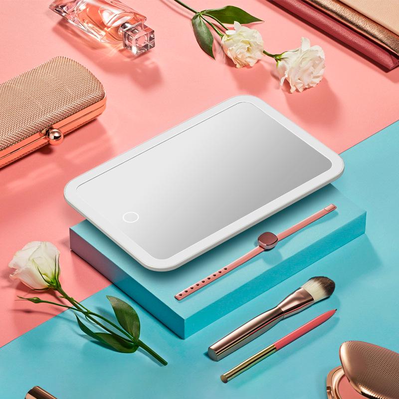 Peach LED Makeup Mirror with Intelligent Touch Dimming, HD Lighting, and Rechargeable Function.