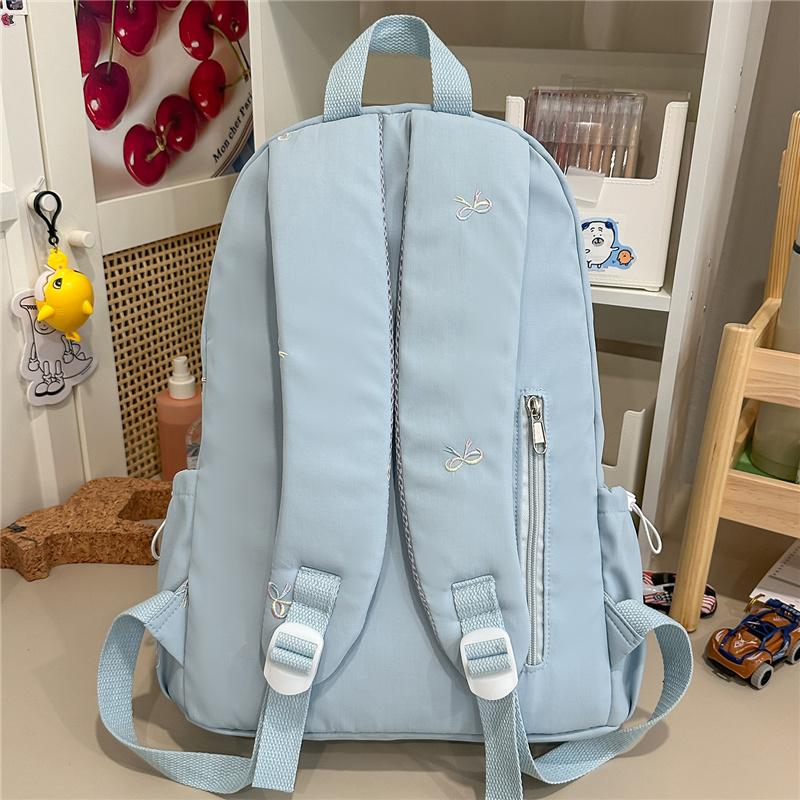 Zaino scolastico carino con ricamo a fiocco, tasca frontale, manico superiore, zainetto casual per uso quotidiano