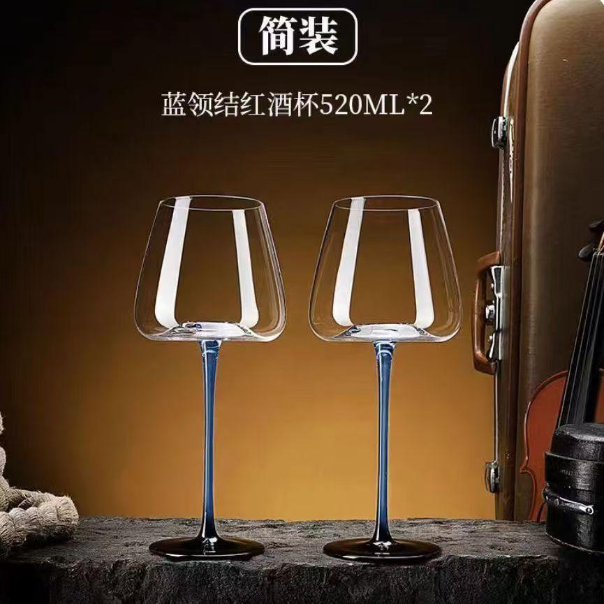 Two sets of red wine glasses