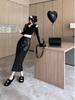 Women's Black PU Leather Midi Skirt: High-Waist, Hip-Hugging, Autumn/Winter 2025 Style.