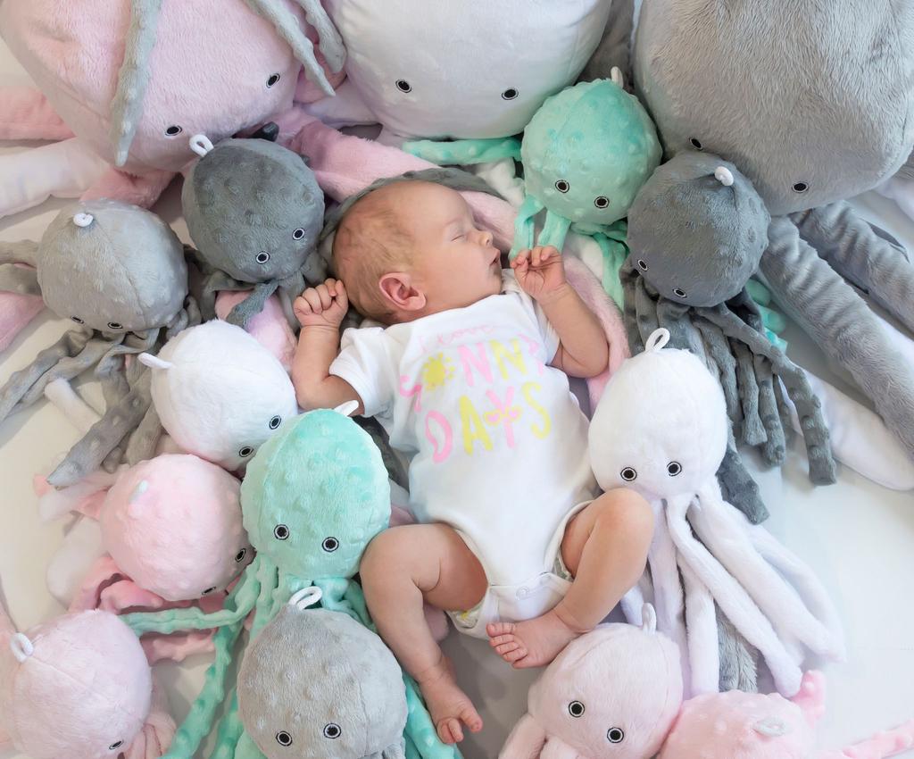 Octopus cuddly toy for children with a rattle - mint