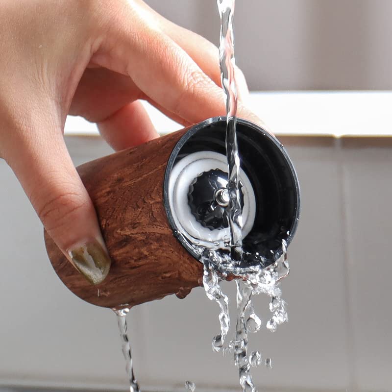 Portable, compact, hand-held coffee grinder with ceramic mortar, 5-degree adjustable grinding angle, washable clear container, natural wood finish,