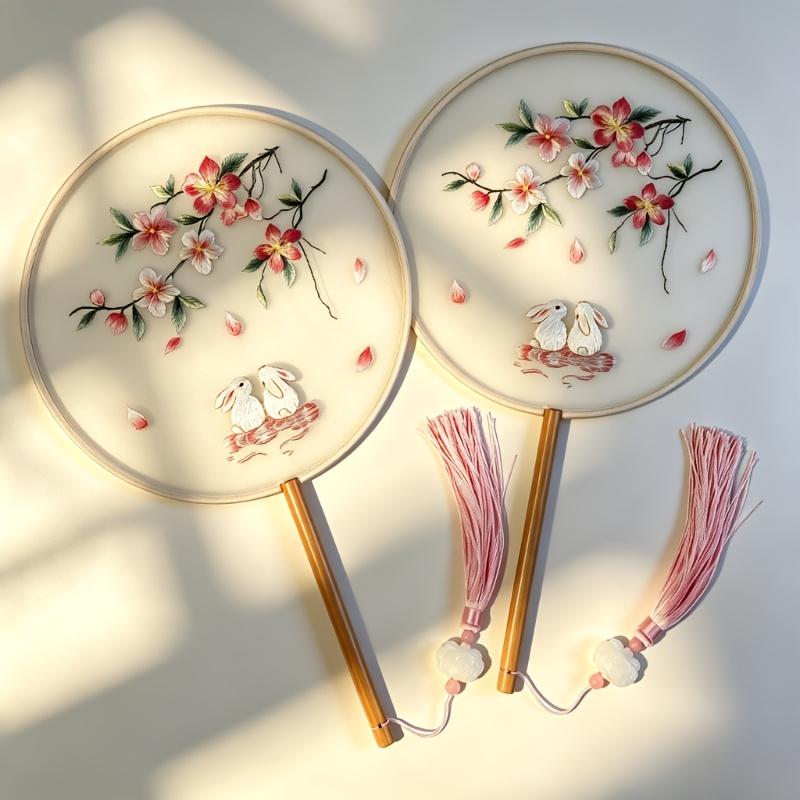 2pcs The peach blossom and jade rabbit embroidered fan features a semi-transparent fabric paired with delicate embroidery of peach blossoms and a 2