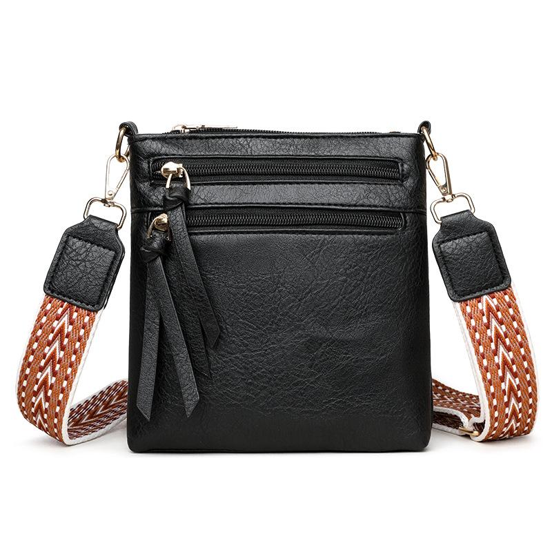 

Вертикальная сумка через плечо с несколькими карманами и широким ремнем