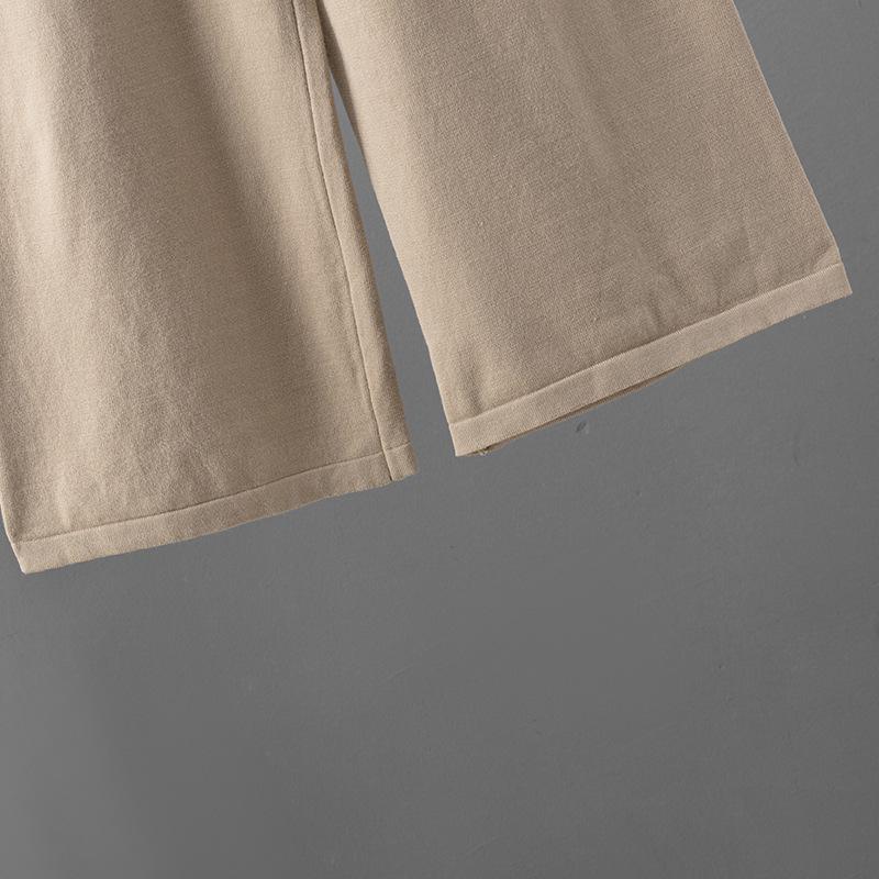 Dámský evropsko-americký dvoudílný oblek se svetrem s výstřihem do V a širokými kalhotami pro podzim/zimu 2025.