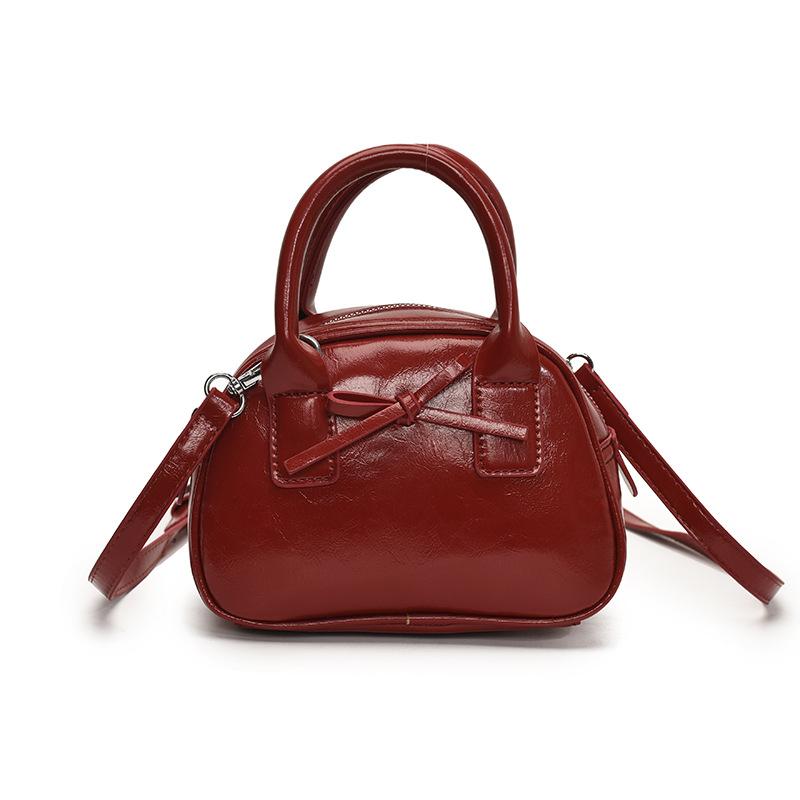 Südkoreas beliebte Nische einfache einfarbige tragbare Bowlingtasche Damen lässig ausländischer Stil hochwertige vielseitige Umhängetasche