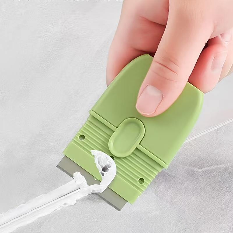 A Mini Scraper with A Protective Cover, A Portable Dual-Headed Ceramic Wall Cleaner, A Tile Scraper, and A Multifunctional Cleaning Tool.
