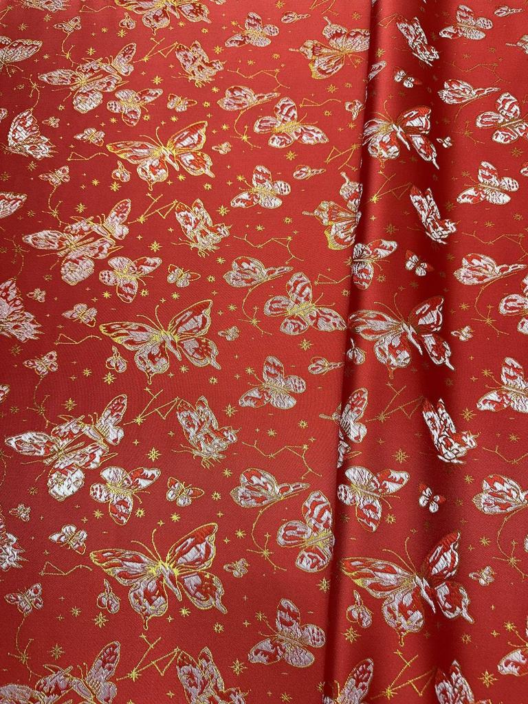 Ethnischer Jacquardstoff für Damen- und Kinderbekleidung in Rosa, Lila, Rot und Gold.