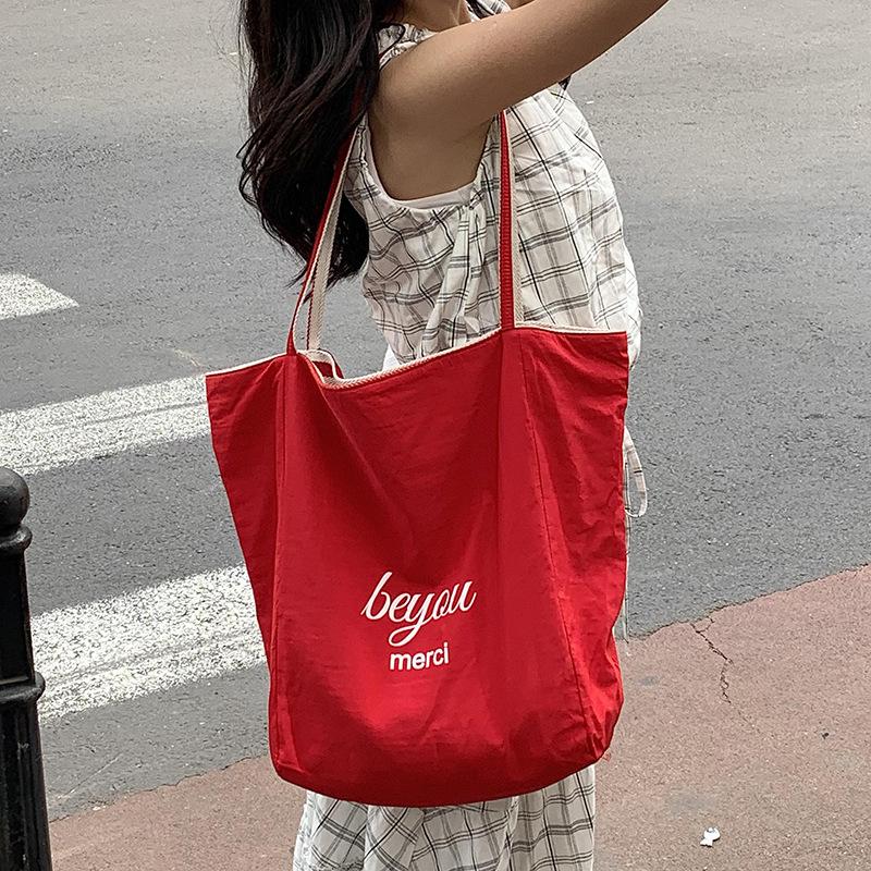 Niche high-value double-sided striped canvas bag 2025 new large-capacity casual versatile commuter shoulder tote bag