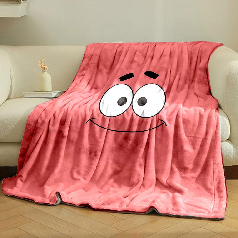 A simple pink background with a smiling cartoon face and wide eyes. for all seasons blanket lunch break throw gift