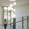 Minimalist Rotating Stair Chandelier: Irregular Long Duplex Pendant with Large Round Ball in Cream