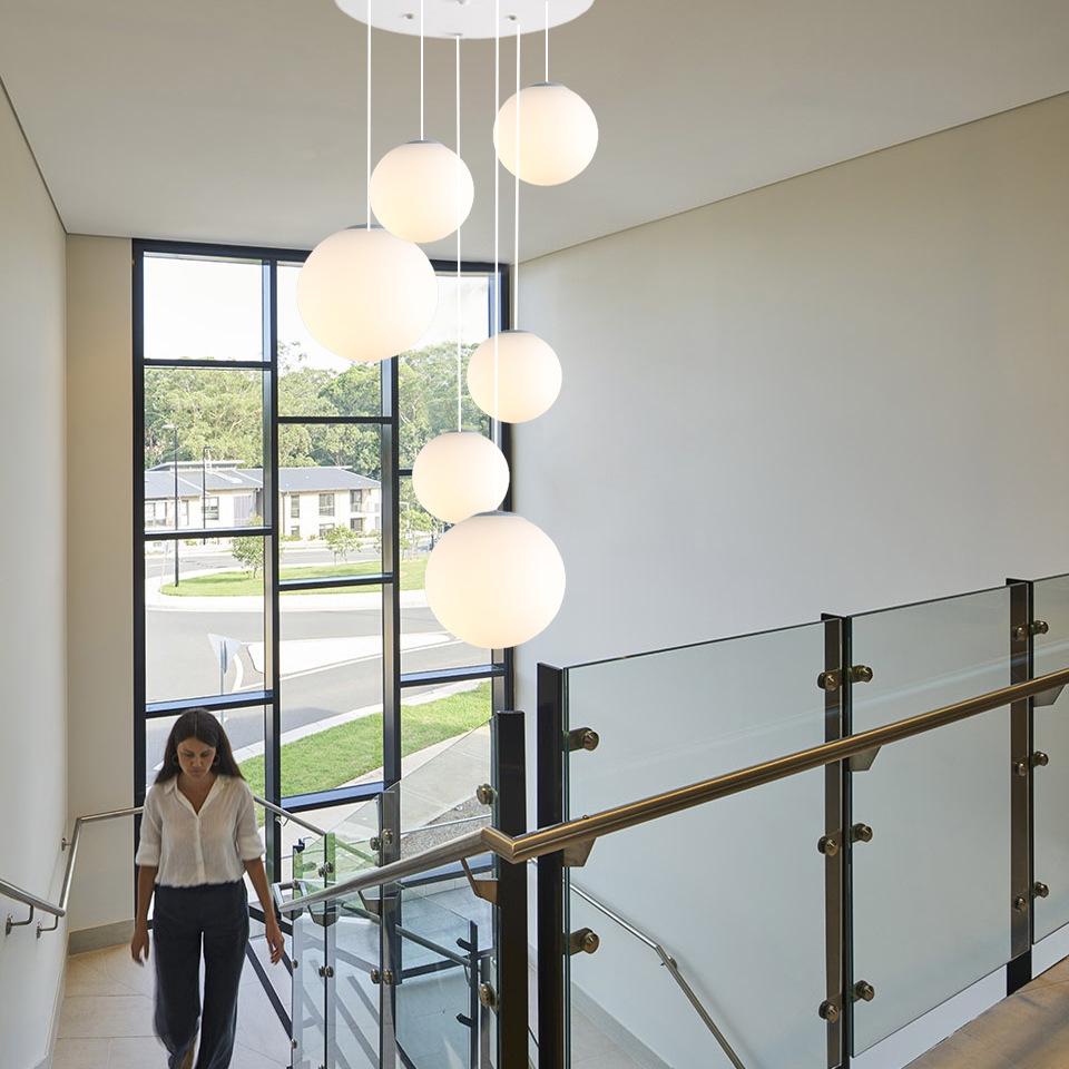 Minimalist Rotating Stair Chandelier: Irregular Long Duplex Pendant with Large Round Ball in Cream