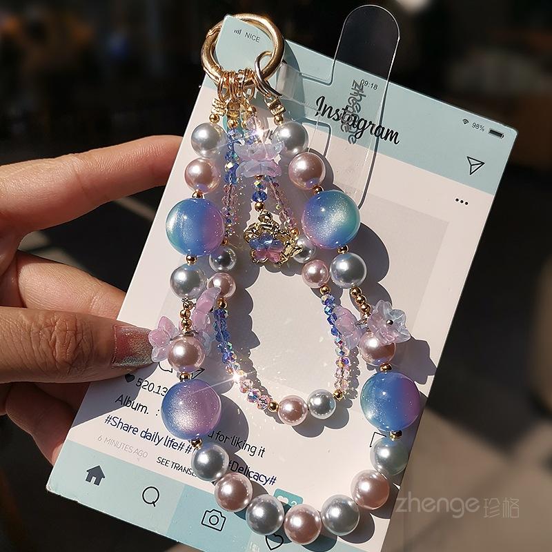 

Handmade crystal mobile phone chain ins style niche light luxury wrist pendant women s high-end pendant bracelet short Blue and pink starry sky crystal pearl bracelet