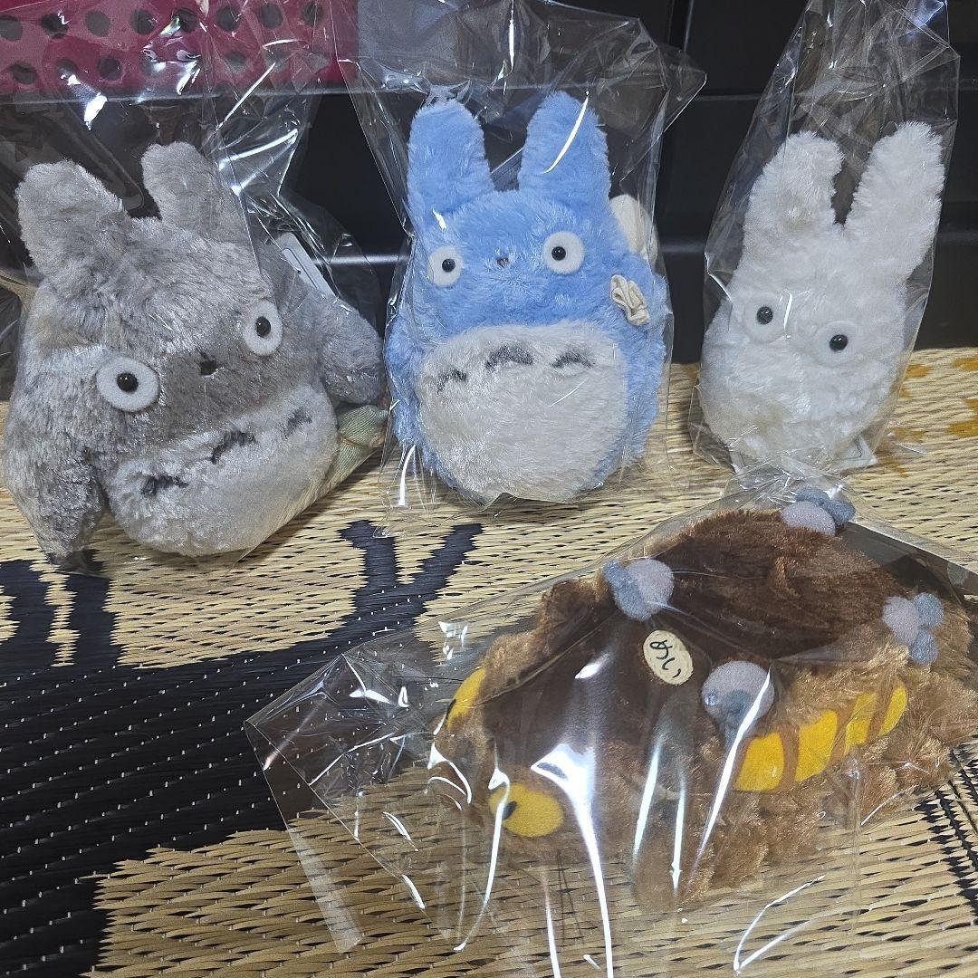 Totoro (gray, blue, white) stuffed animal and cat bus
