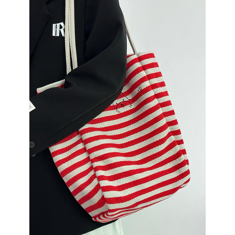 Large capacity striped canvas bag women's 2025 new niche embroidery lazy wind commuter portable shoulder tote bag