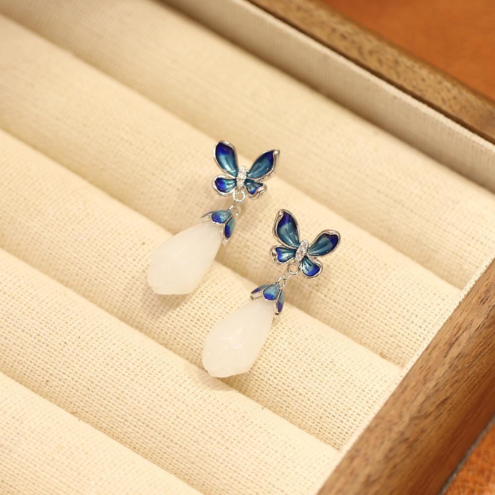 Elegant and elegant blue dripping butterfly stud earrings with simple temperament white magnolia flower imitation jade earrings silver needle women's