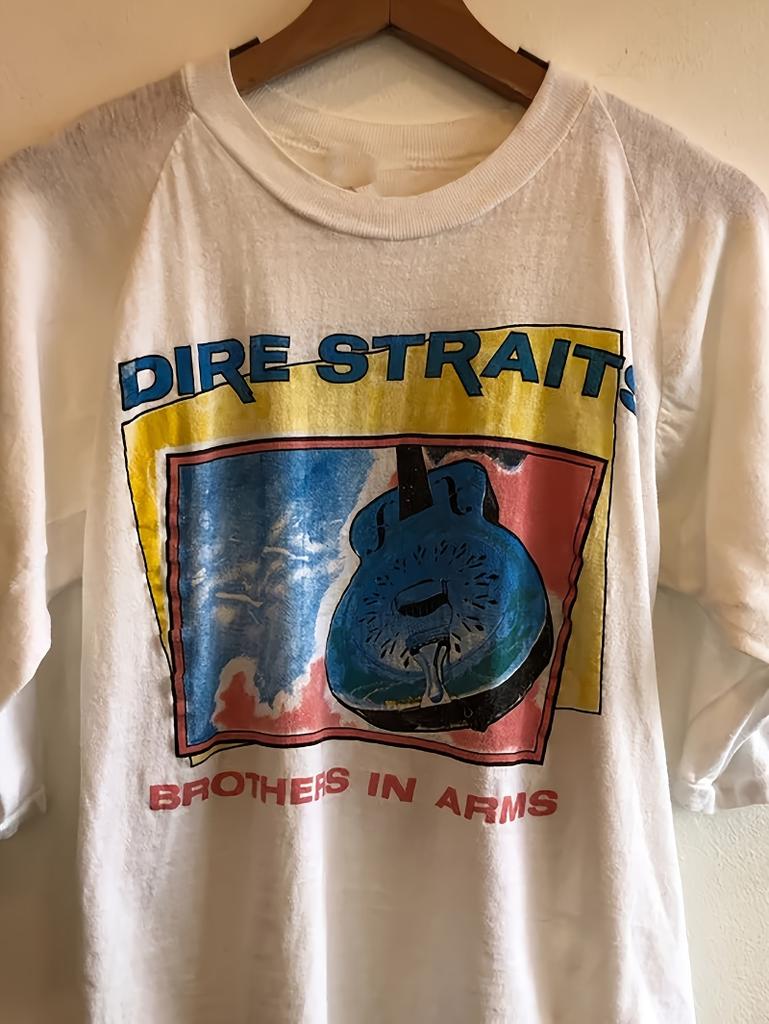Vintage Patterned Tshirt Commemorating Dire Straits 1985 Brothers In Arms Tour Featuring Iconic Guitar And Stage Design