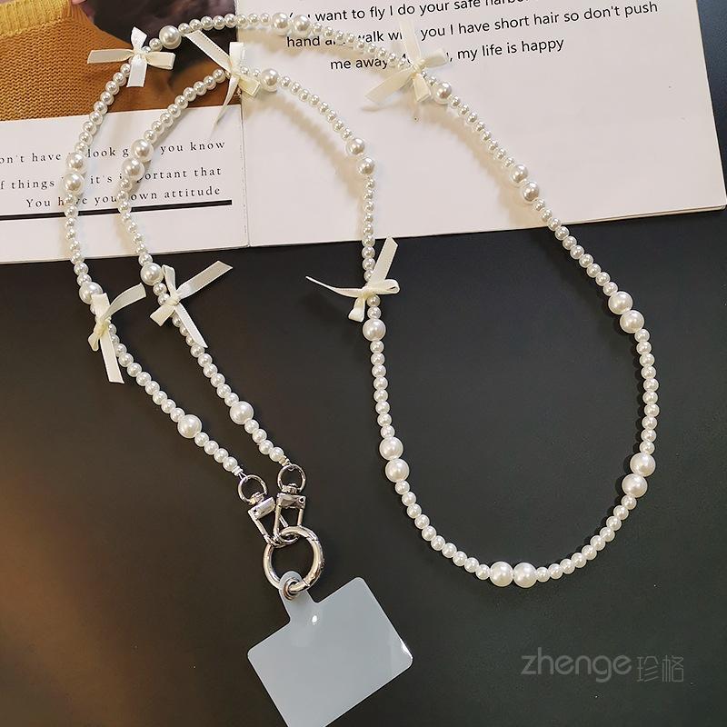 

Crossbody bow pearl lanyard women s ins outdoor fashion small fresh back chain long mobile phone lanyard Crossbody bag [white]