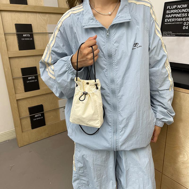 Minimalist style Japan and South Korea light drawstring canvas trend 2025 personalized solid color shoulder crossbody change mobile phone bag women's