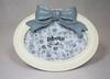 A charming white oval-shaped frame decorated with a bow