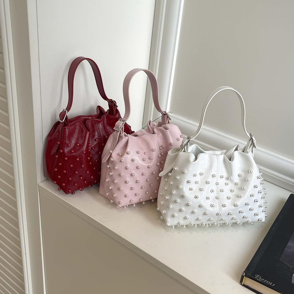 Trend European and American fashion rivets spring and summer armpit women's bags simple and versatile portable bucket bags single shoulder oblique spa