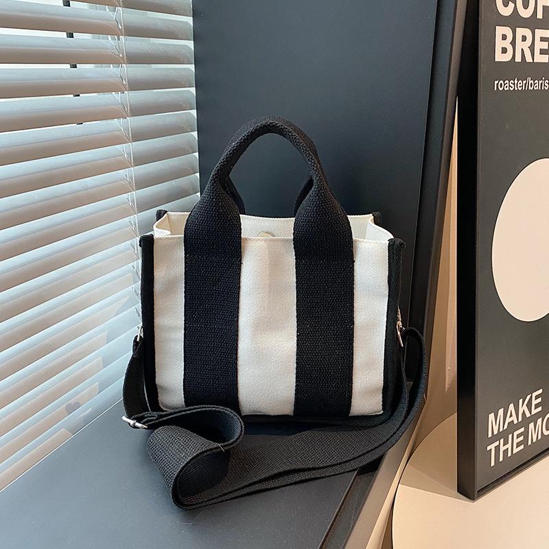 2025 fashion new women's bag niche design color matching canvas bag foreign style portable magnetic buckle bag versatile shoulder bag tide